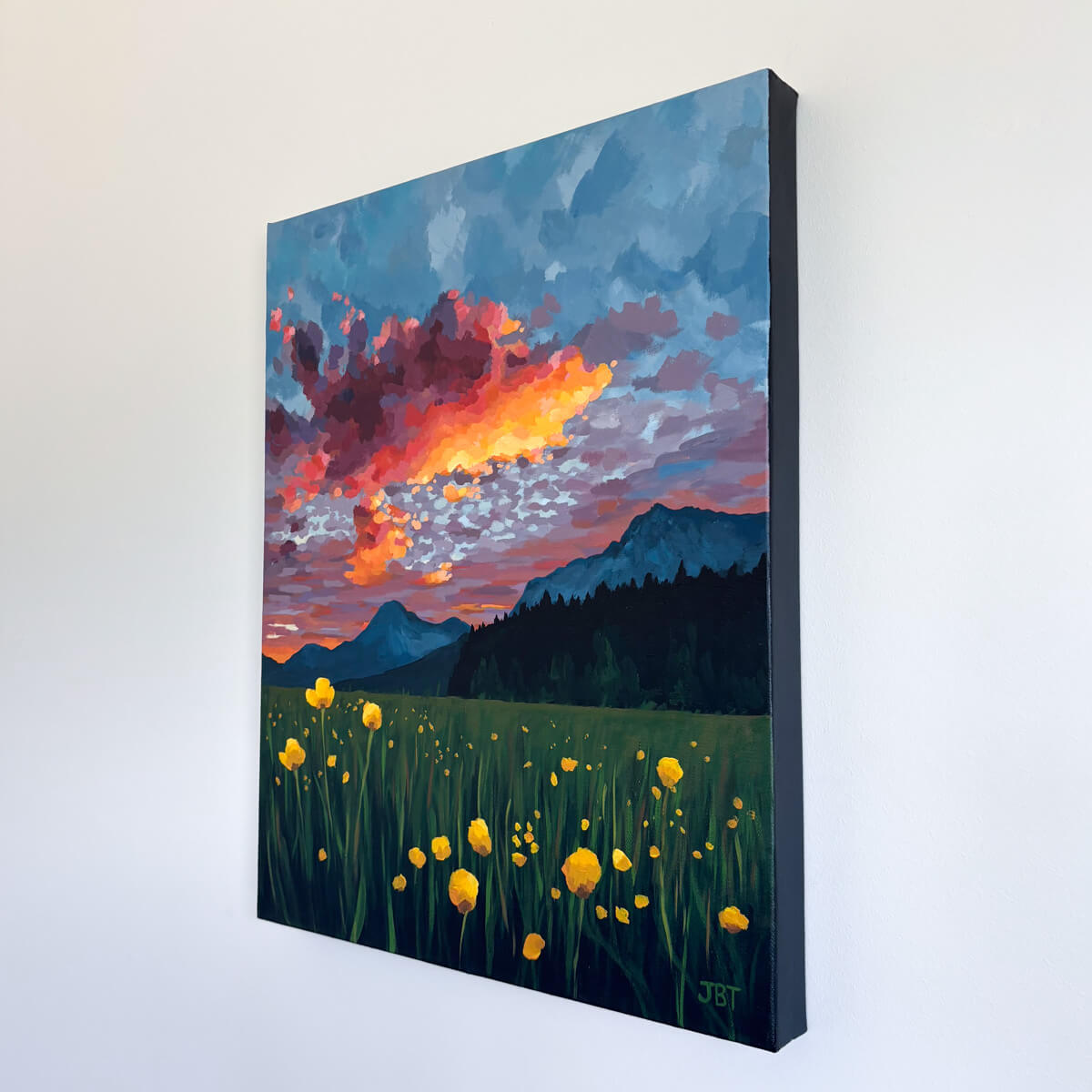 painting featuring colorful clouds, mountains, and yellow flowers