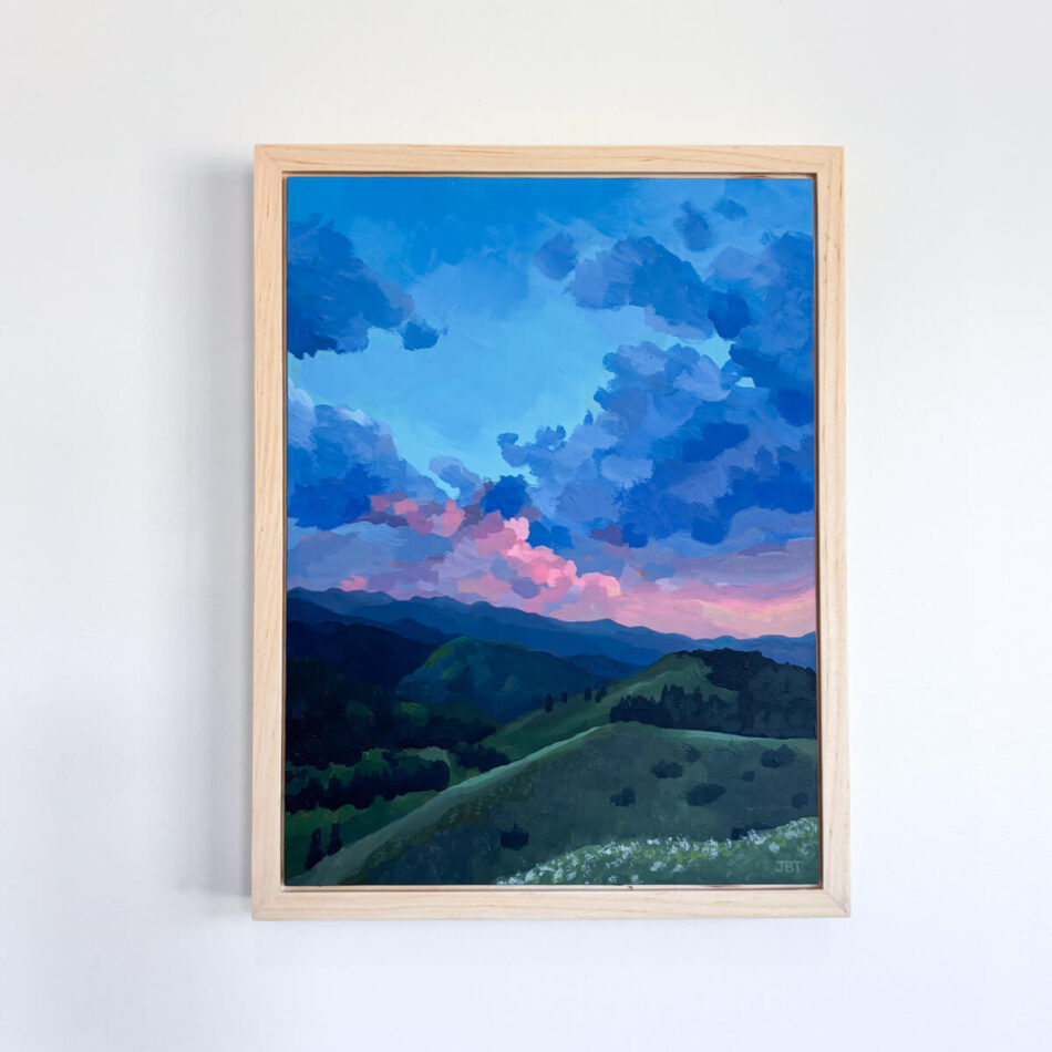 painting with a dramatic sunset sky and green hills